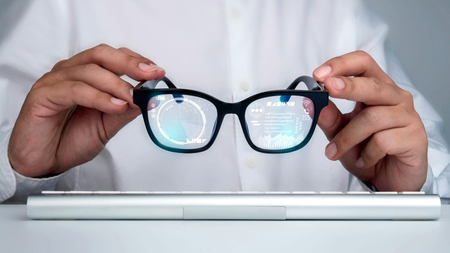 Someone holding smart glasses.