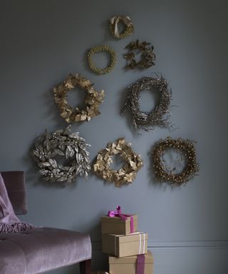 Alternative Christmas tree ideas with a tree shape made from wreaths on a wall