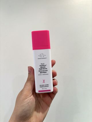 Mica Ricketts holding Drunk Elephant T.L.C. Framboos Night Serum