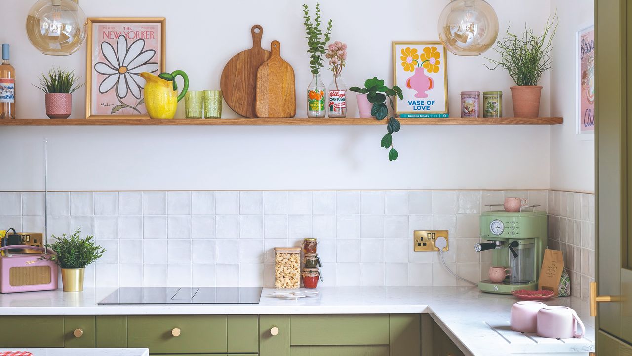 A green kitchen with a white tiled splashback