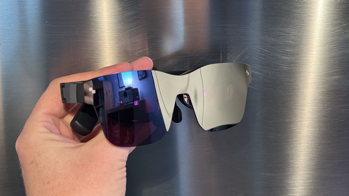 The TCL RayNeo Air 2 smart glasses on steel and wooden surfaces