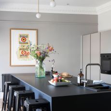 kitchen room with grey countertop and stools