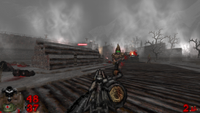 The player assaults a fortification in the Doom 2 mod Butcher's Summit, moving through a foggy landscape dotted by gnarled trees while being attacked by green-eyed, pointed hood-wearing cultists.