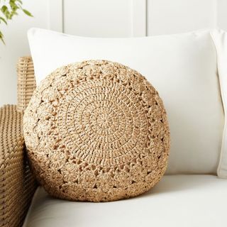 Hand-Crochet Outdoor Cushion on a white armchair. 