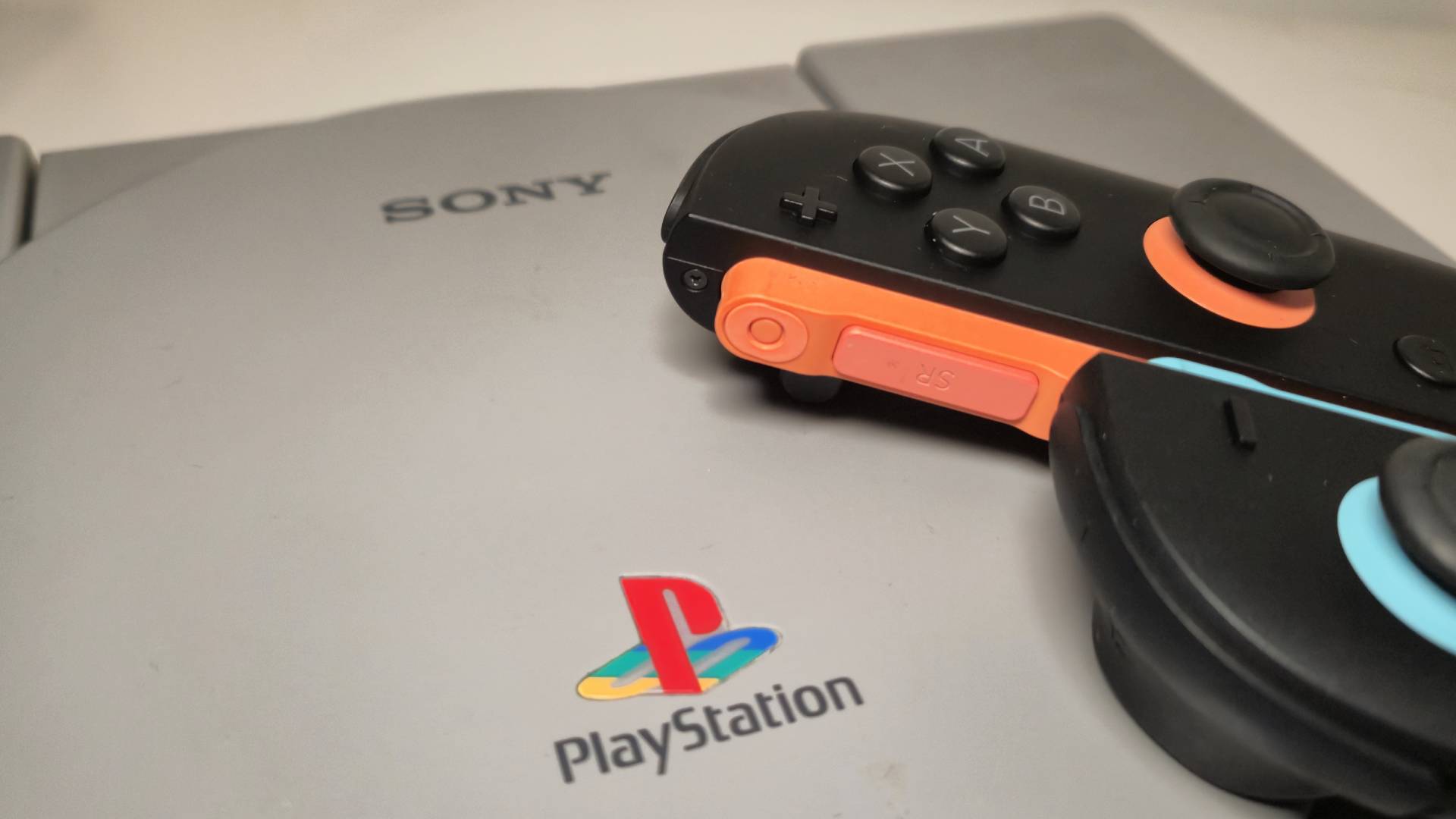 Image of a pair of Switch 2 Joy-Con sitting on an original PlayStation console.