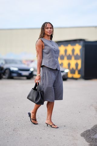 woman wearing tailored bermuda shorts with tailored vest