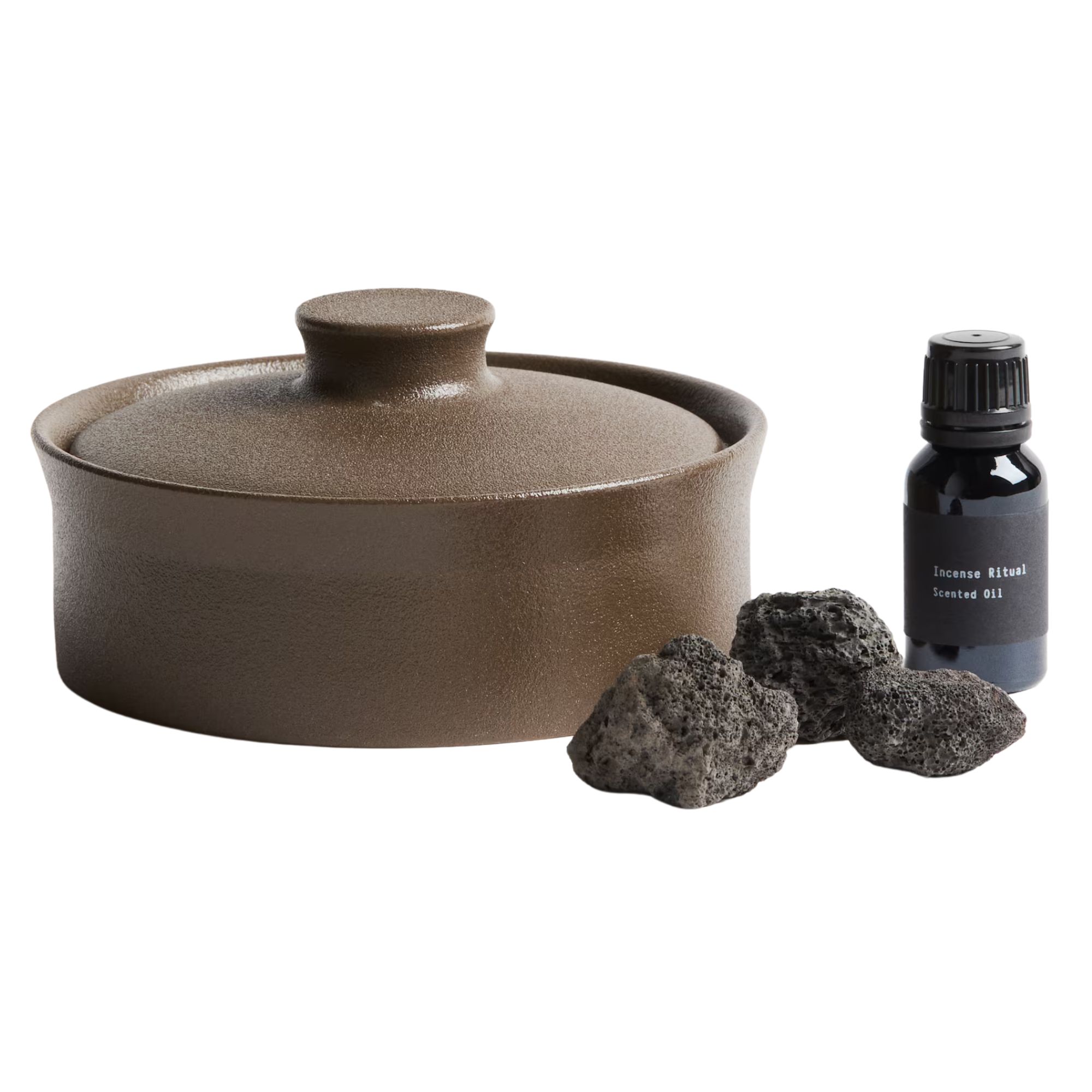 H&amp;amp;M brown ceramic Lava Stone Diffuser with three black lava stones and a black glass bottle of essential oil with black label, white text, and black lid.