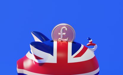 Piggy bank textured with British flag and pound coin over blue background. Horizontal composition with copy space.