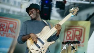 Richard Bona performs on stage with a five string bass circa 2000.