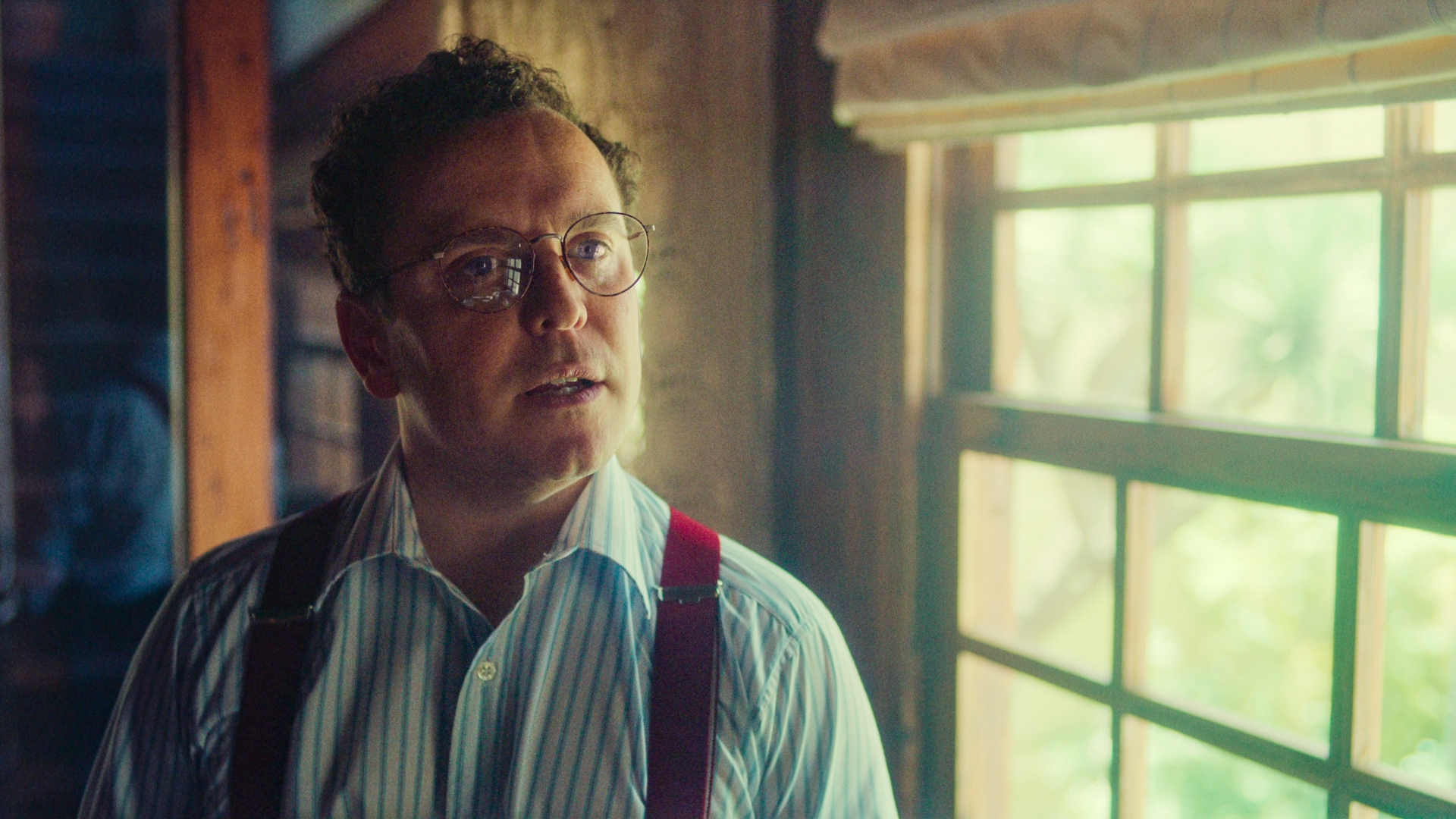 Douglas stands by a window in The Gold season 2