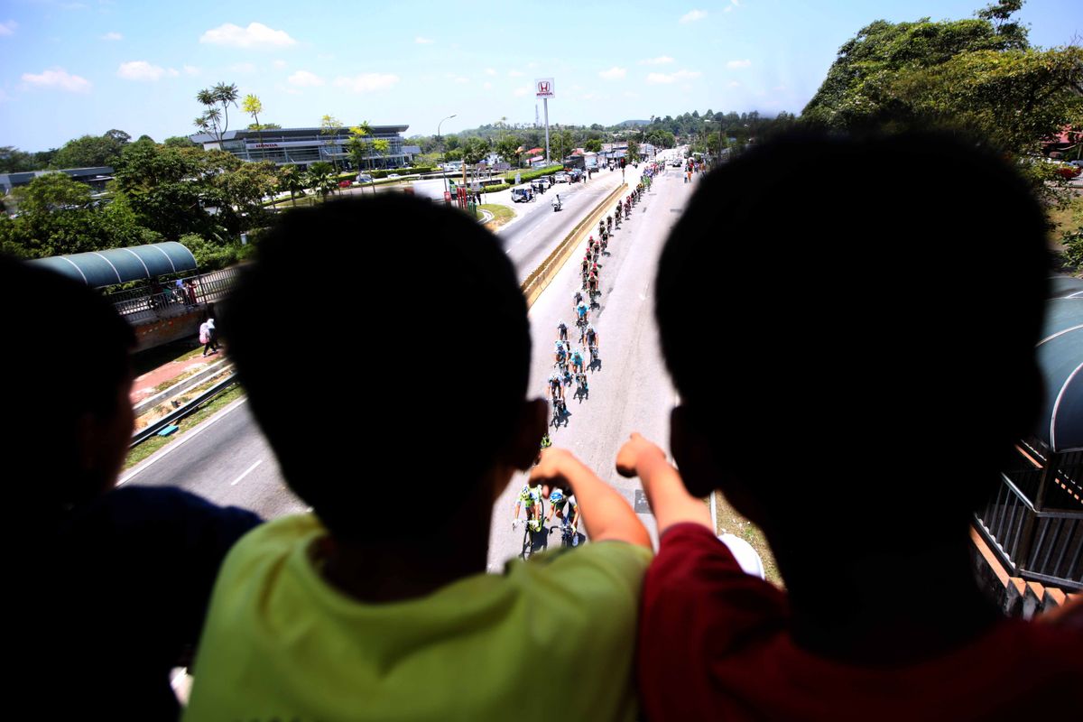 Fans watch the riders do by