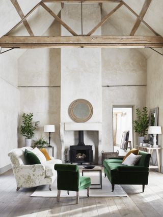 A living room by Neptune with green velvet sofa and woodburning stove