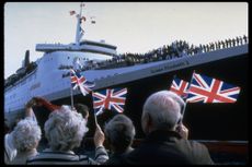 Well-wishers waving British flags as they bid farewell to troops leaving for Falkland Islands