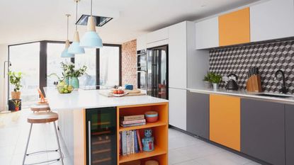 A grey and orange modern kitchen with island, wine fridge and shelving