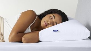 A woman sleeps on her side with the Casper Original Pillow