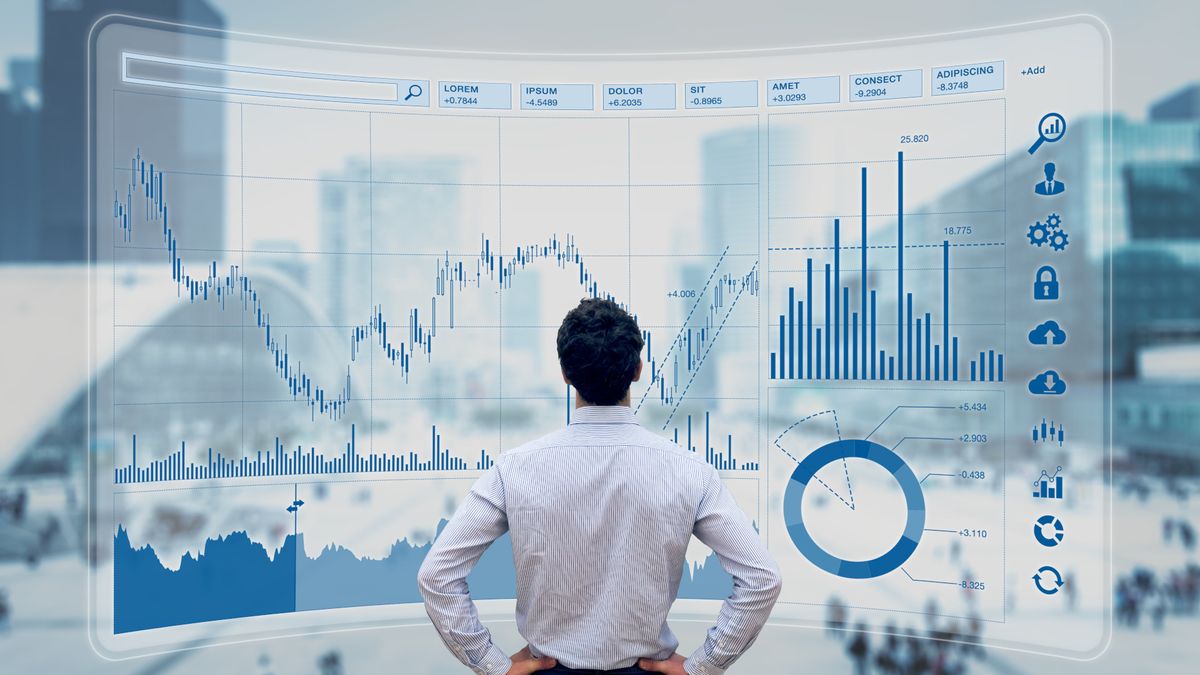 A man standing in front of a giant digital progress graph