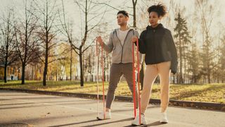 A man and woman trying a resistance band workout