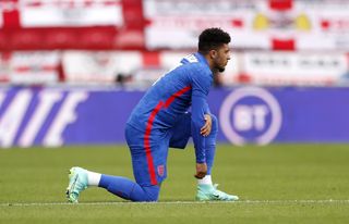 Jadon Sancho takes a knee before the Romania game