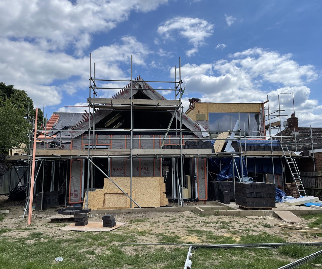 A self-build in progress with scaffolding and a pitched roof