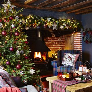 Traditional living room, with a large decorated Christmas tree and a wood burning fireplace