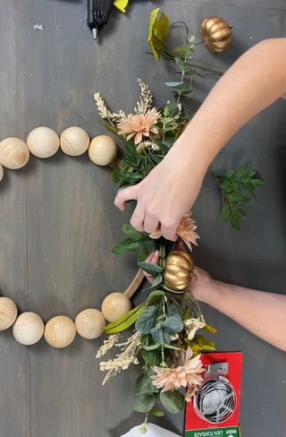 Assembling DIY fall wreath with beads
