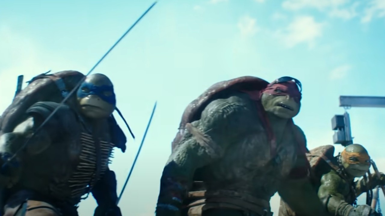 The Ninja Turtles standing on a roof in Teenage Mutant Ninja Turtles