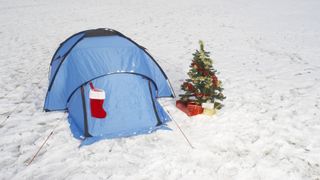 Christmas tree and tent in snow