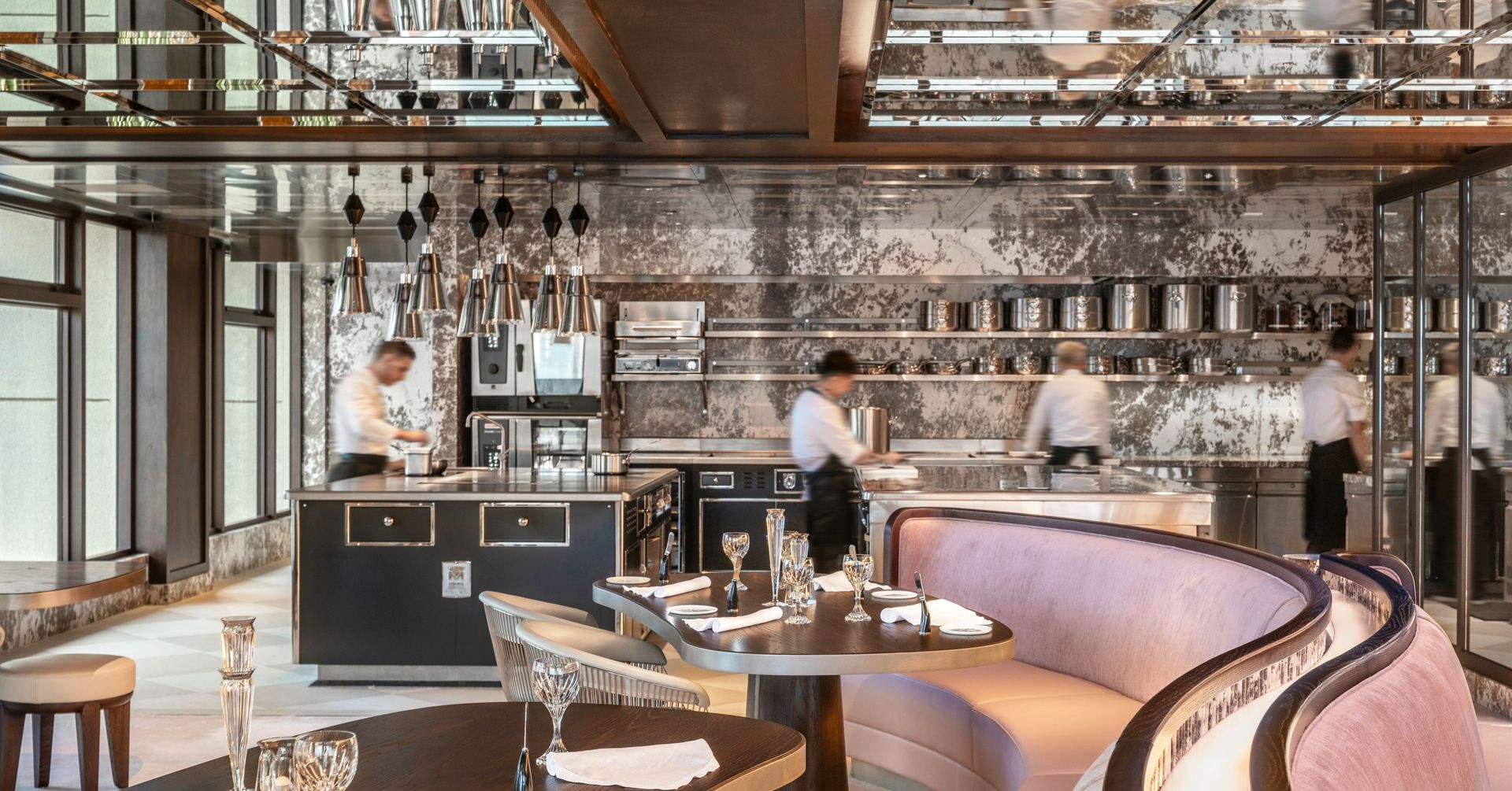 Interior of Cristal Room with curving banquette and staff at work