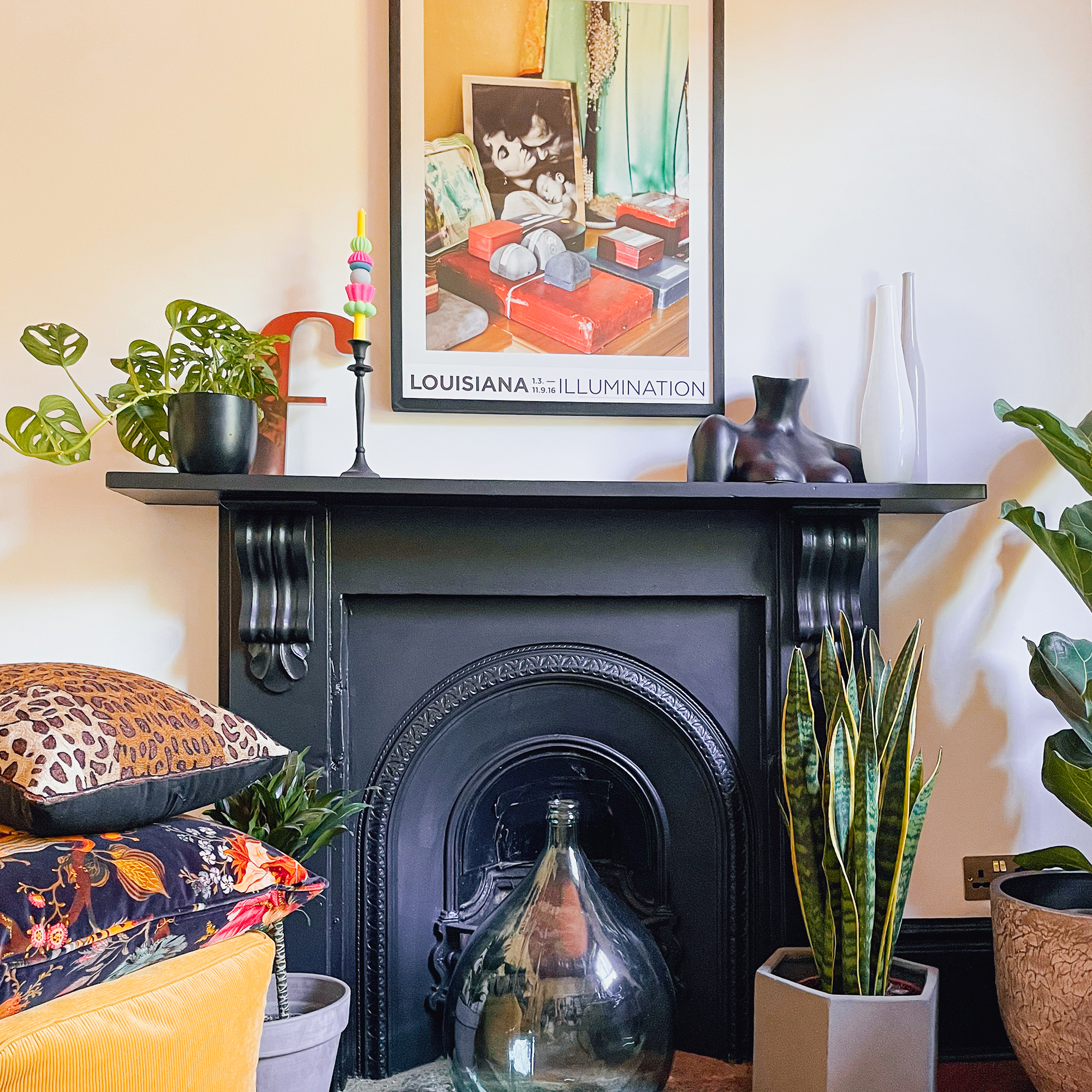 fireplace with Louisiana poster above it