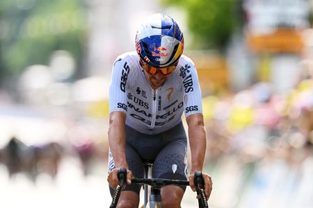 Tom Pidcock crosses the line with his head down, third on stage 9 of 2026 Tour de France