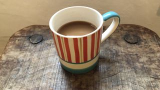 stripy mug of mocha on table