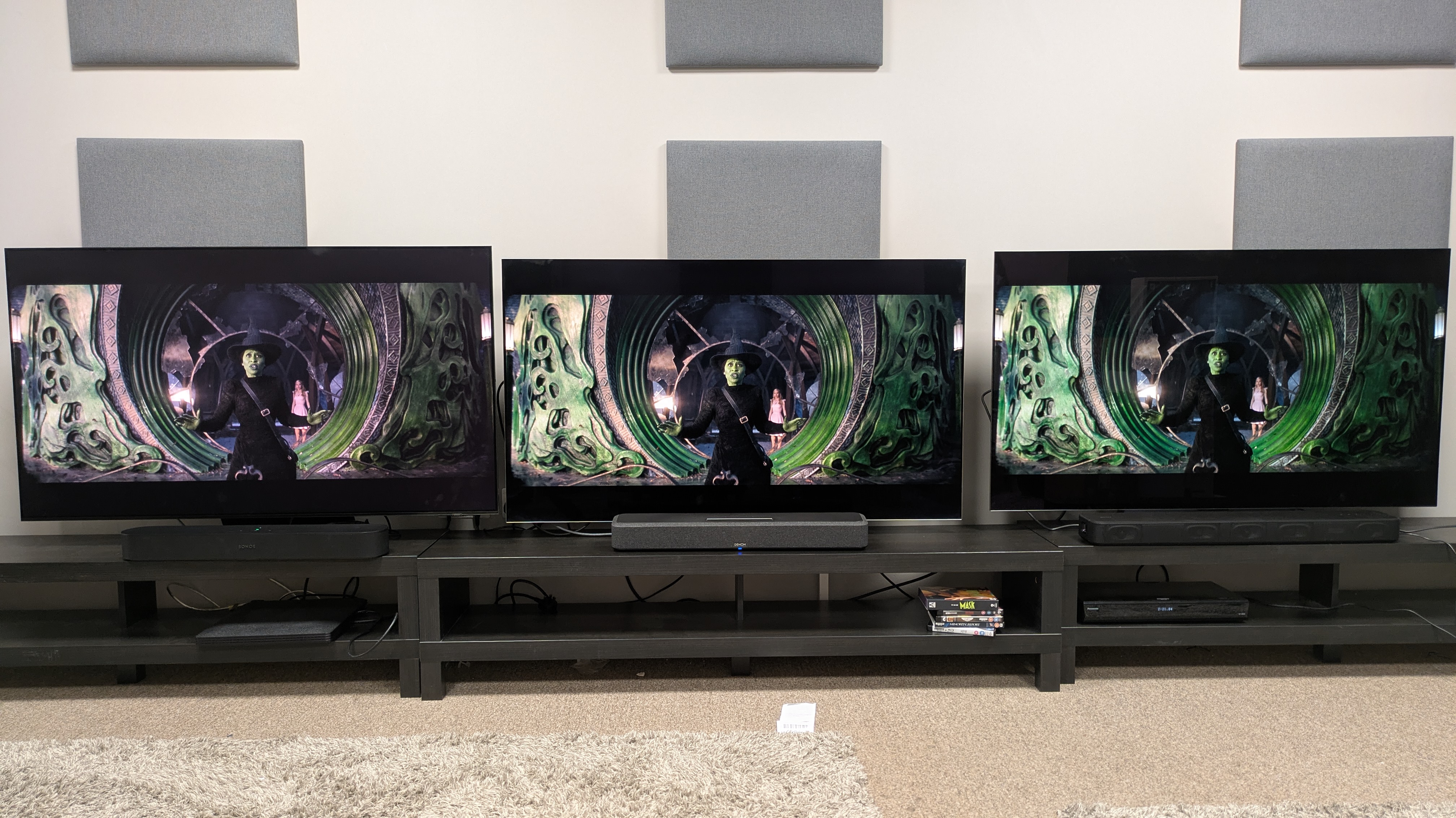 Sonos Beam (Gen 2) (left) under Samsung S95F , Denon Home 550 (middle) under LG G5 and Sony HT-S2000 (right) under LG C5, all showing Elphaba from wicked