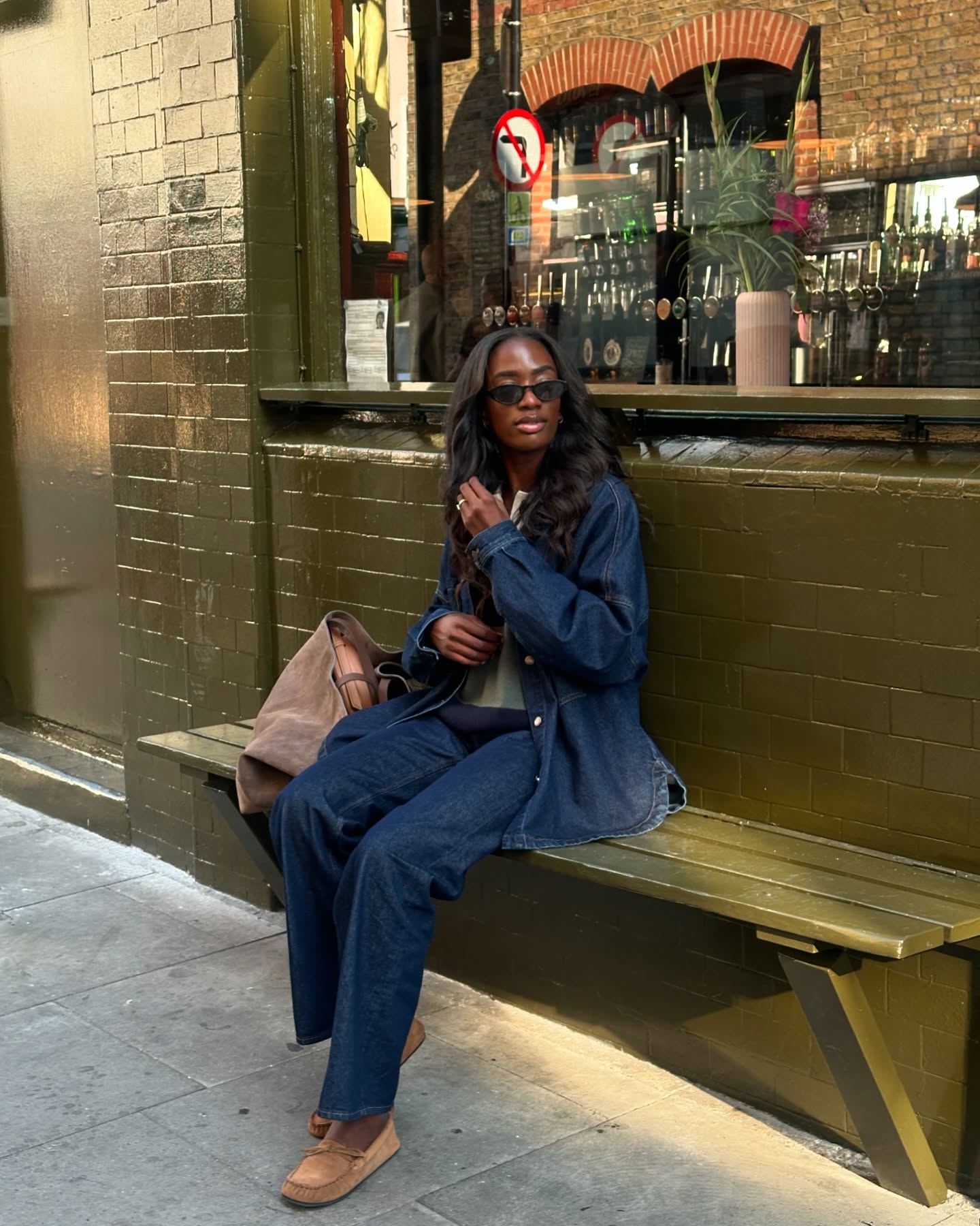 Influencer @_livmadeline wears a denim shirt over a rugby shirt with jeans and suede flats.