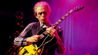 Steve Howe performing live onstage, playing Gibson ES-175 guitar