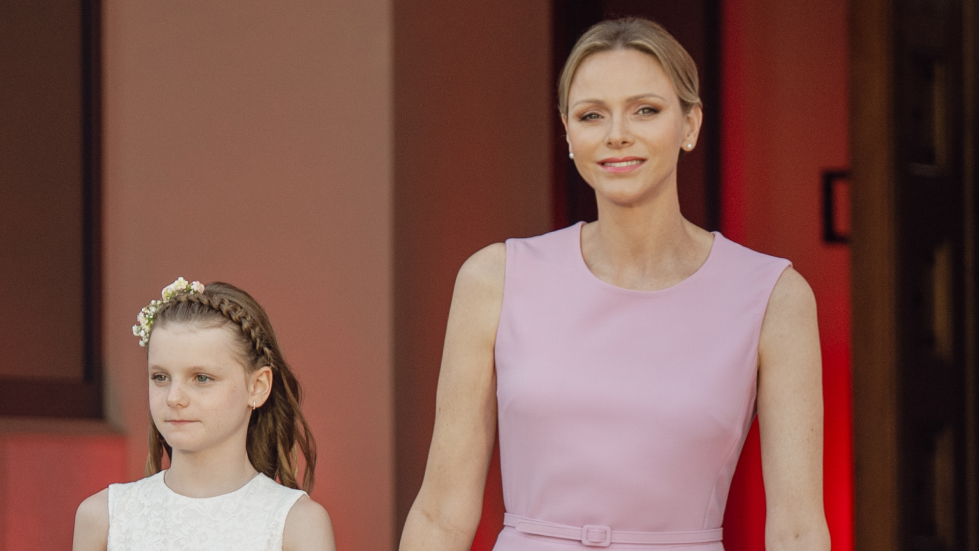 Princess Charlene wears a pink Barbiecore Oscar de la Renta dress and poses with daughter Princess Gabriella