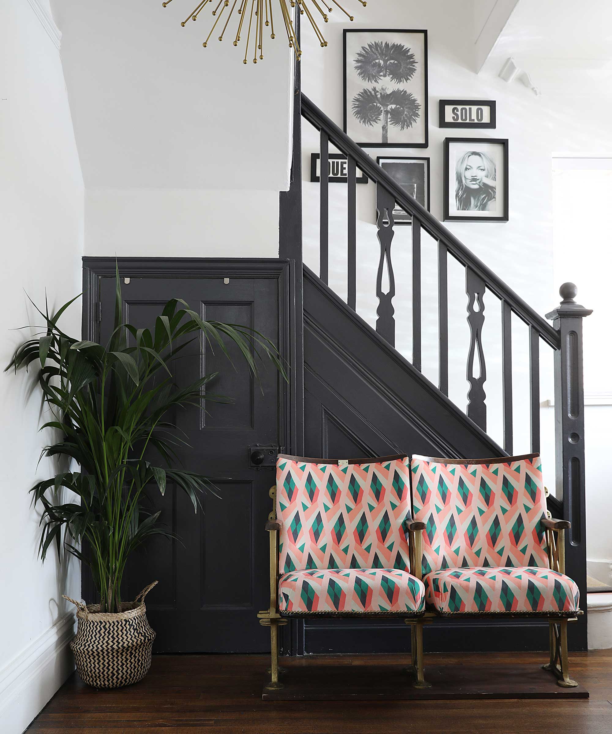 hallway in an Edwardian house with dark painted staircase and white walls