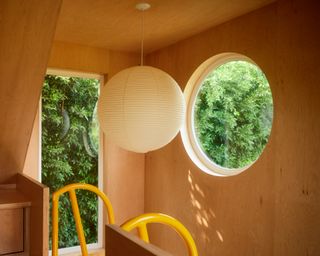 round window on the upper level looking out at the Monon Guesthouse by Jerome Byron