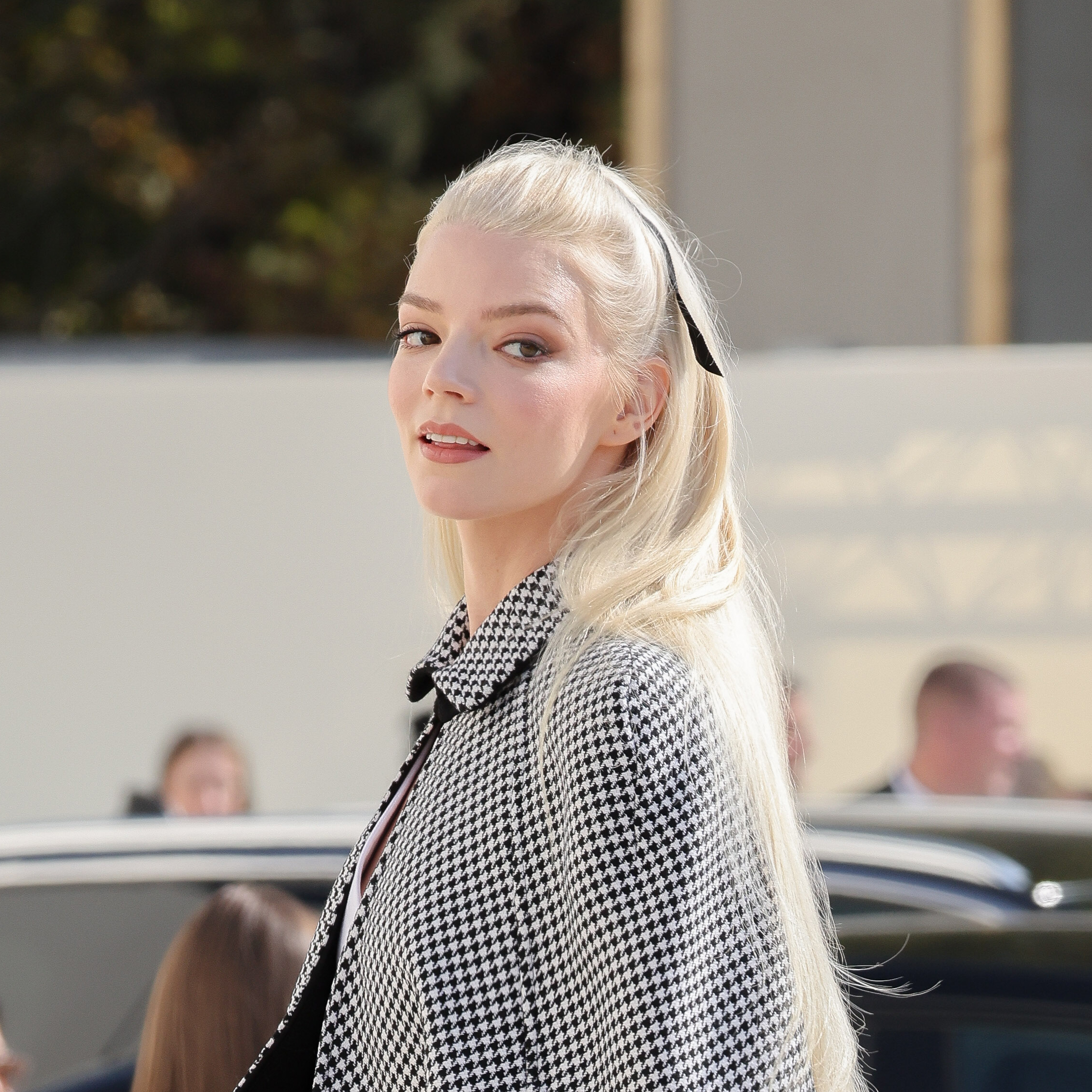 Anyea Taylor-Joy wearing a black and white coat