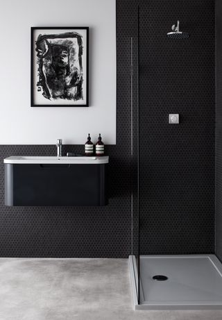 Black wet room tiles with shower enclosure and matching vanity