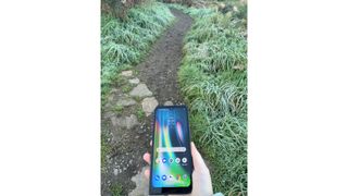 Walking on the trail holding a smartphone