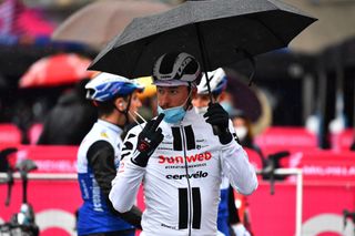 The riders borrowed umbrellas for the sign-on