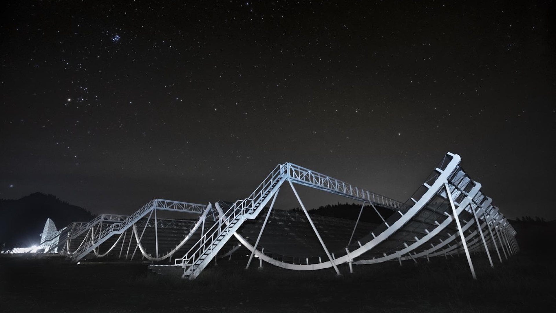 A photo of the CHIME telescope array at night
