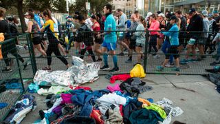 Runners shed protective clothing as they make their way to the starting line for the 48th running of the Chevron Houston Marathon Sunday, Jan. 19, 2020 in Houston