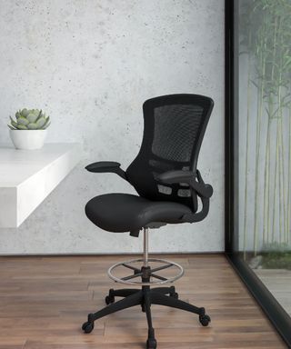 An office chair in a small office with glass door