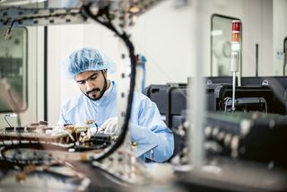 An engineer at work on the Hope orbiter in the clean room.