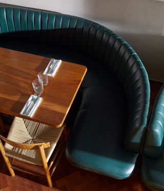 Green leather sofa and wooden table