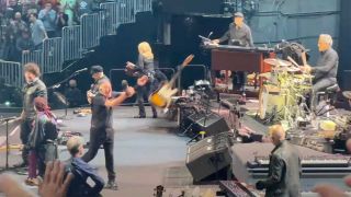 Bruce Springsteen throwing his guitar offstage