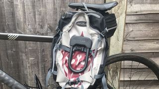 Hiplock D mounted on a rucksack slung over a hybrid bike