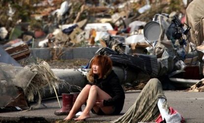 A tsunami survivor weeps amid the debris in the devastated town of Natori, Miyahi prefecture.