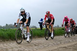 ROUBAIX, FRANCE - APRIL 13: (L-R)Rory Townsend of Ireland and Team Q36.5 Pro Cycling and Markus Hoelgaard of Norway and Team Uno-X Mobility compete passing through the Artres a Famars cobblestones sector while fans cheer during the 122nd Paris - Roubaix 2025 a 259.2km one day race from Compiegne to Roubaix / #UCIWT / on April 13, 2025 in Roubaix, France. (Photo by Dario Belingheri/Getty Images)